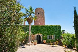 A converted 'finca' or farmhouse in Ses Alqueries, Mallorca, Spain with windmill.